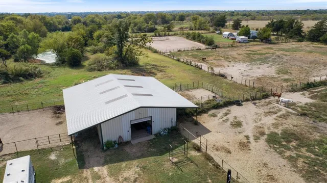 an aerial view of a house with a yard