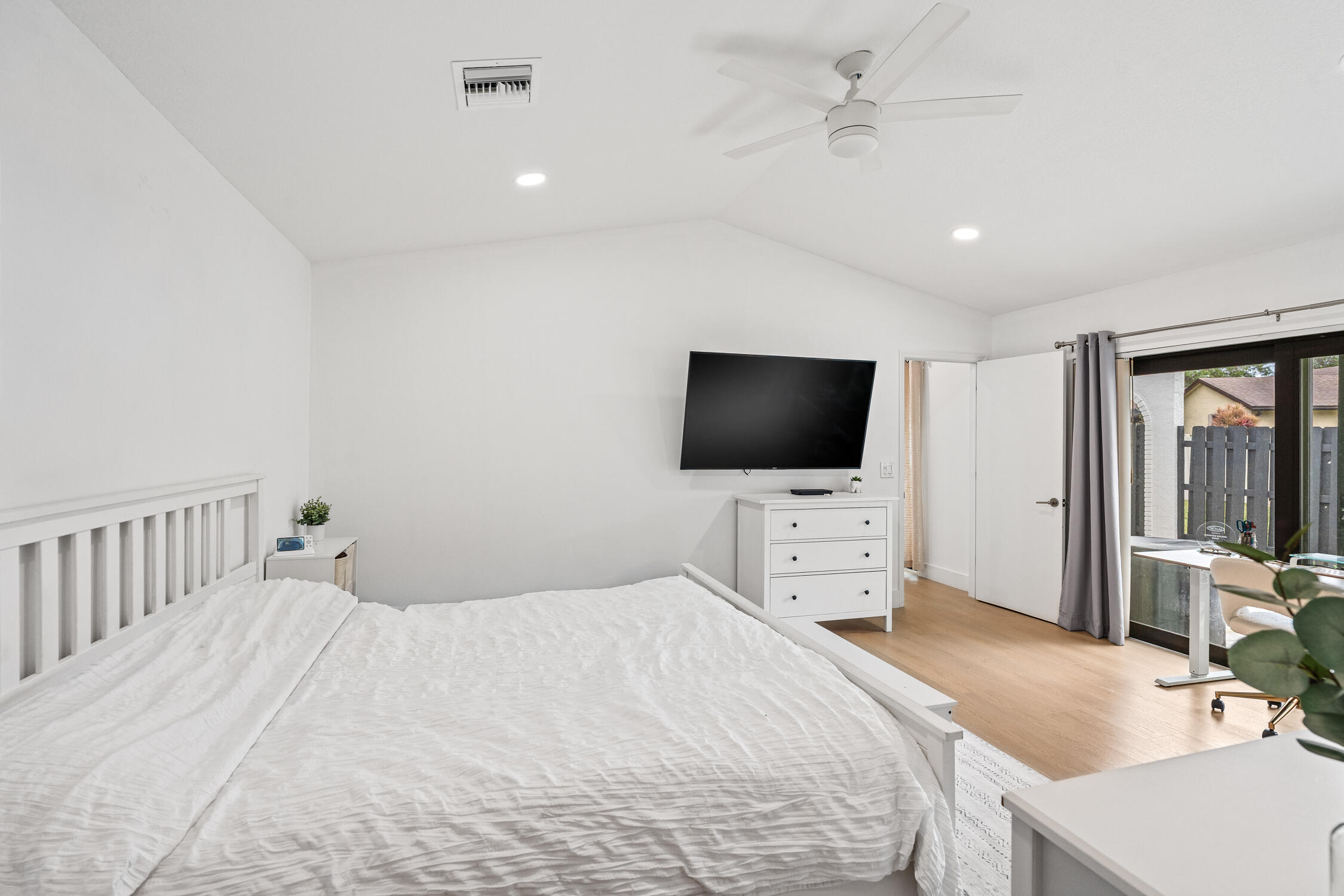 23368 Southwest 53rd Avenue, Unit C Boca Raton, FL 33433 - Photo 13 of 32 a bedroom with a bed and a flat screen tv