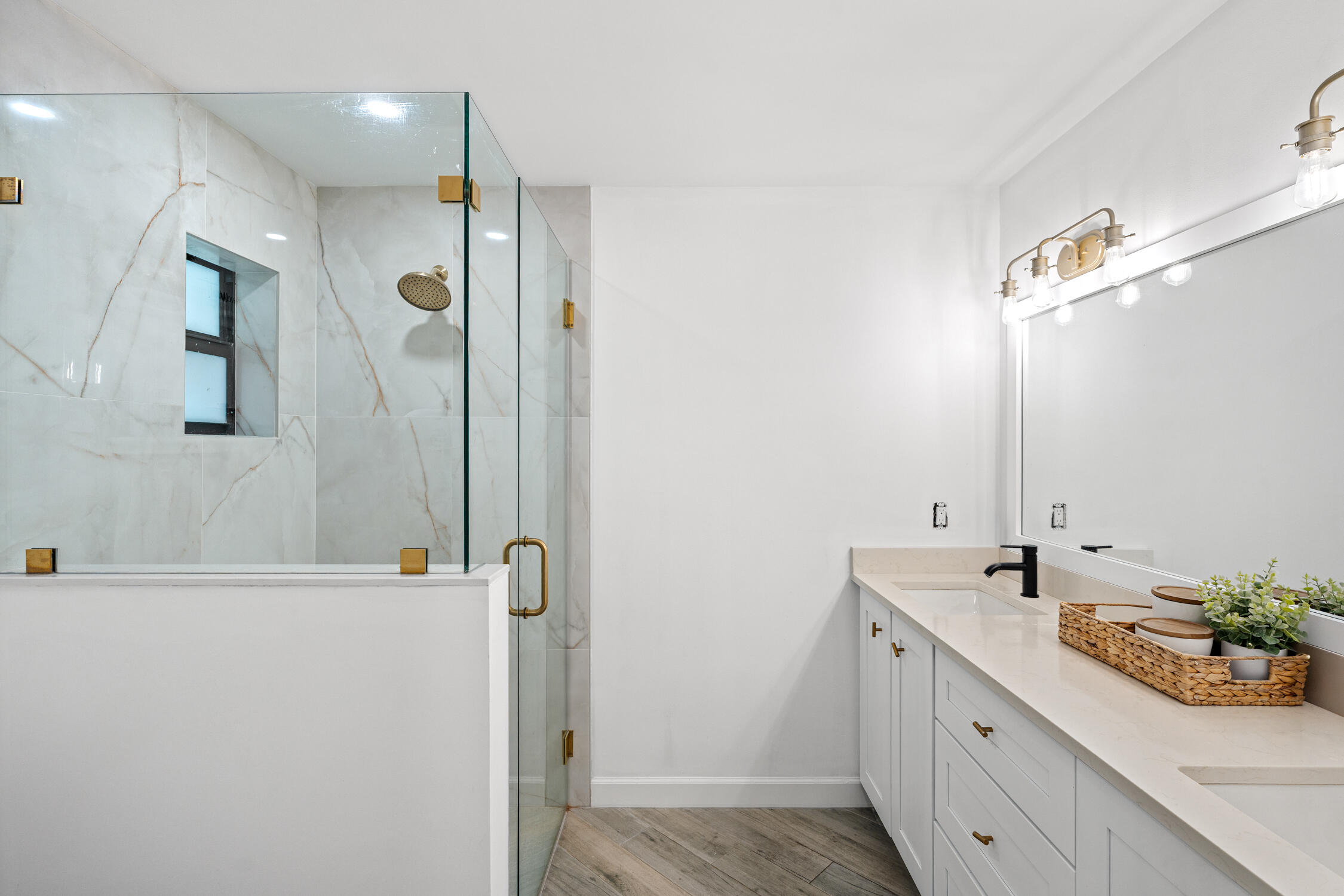 23368 Southwest 53rd Avenue, Unit C Boca Raton, FL 33433 - Photo 14 of 32 a bathroom with a double vanity sink a mirror and shower