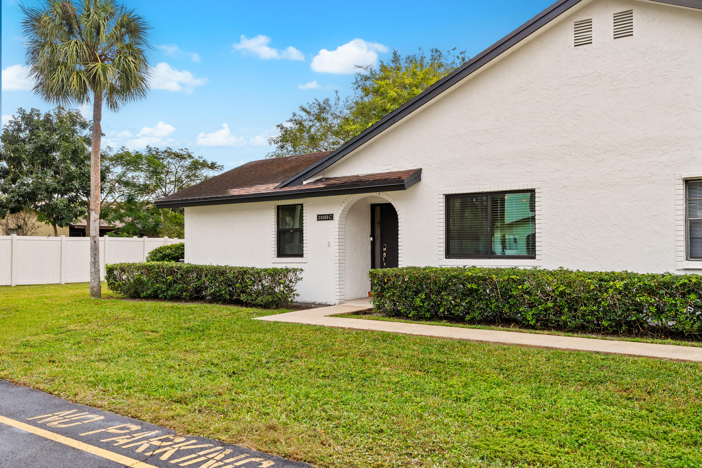 23368 Southwest 53rd Avenue, Unit C Boca Raton, FL 33433 - Photo 25 of 32 a front view of house with yard and green space