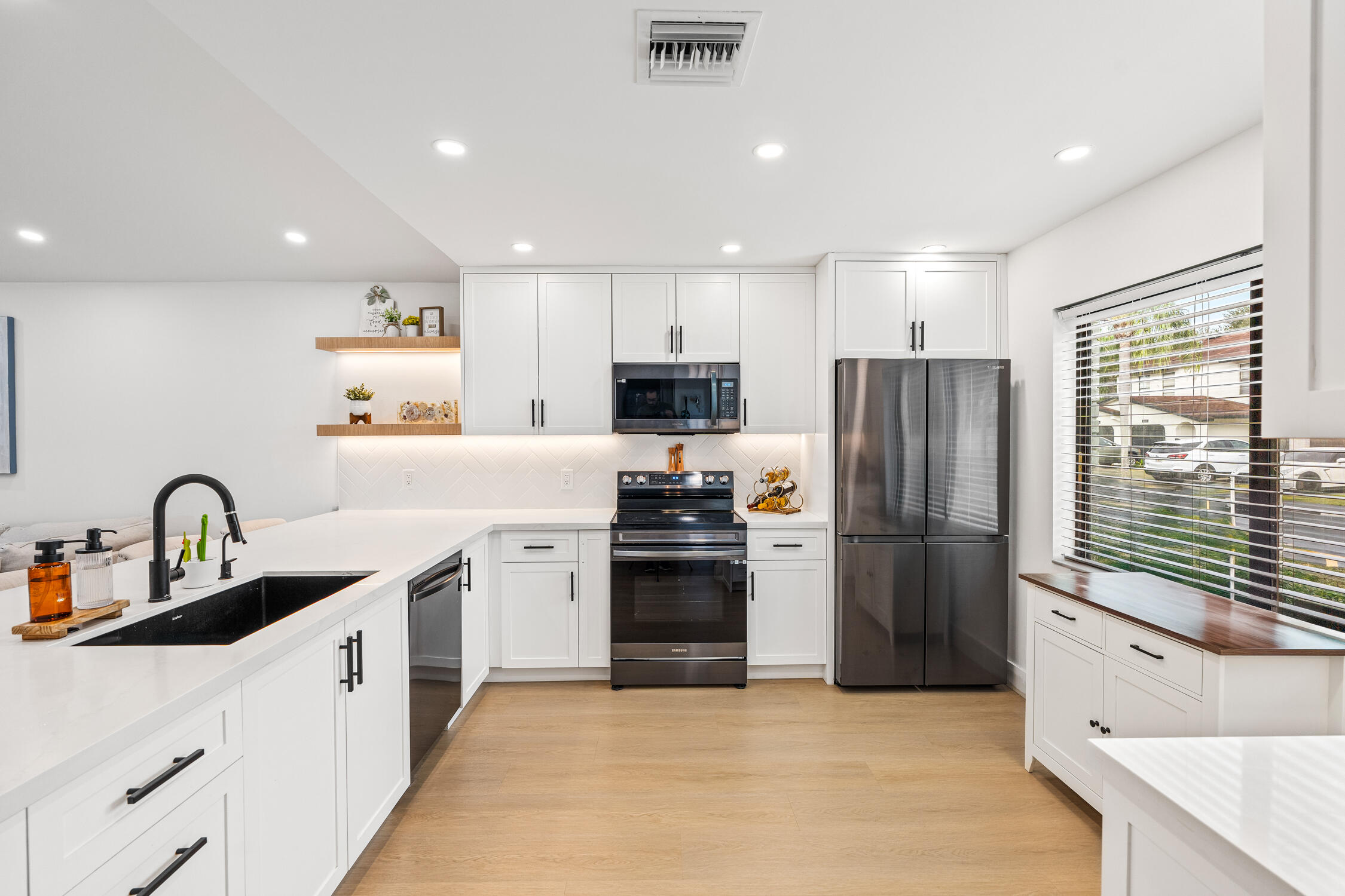 23368 Southwest 53rd Avenue, Unit C Boca Raton, FL 33433 - Photo 3 of 32 a kitchen with a refrigerator and a sink