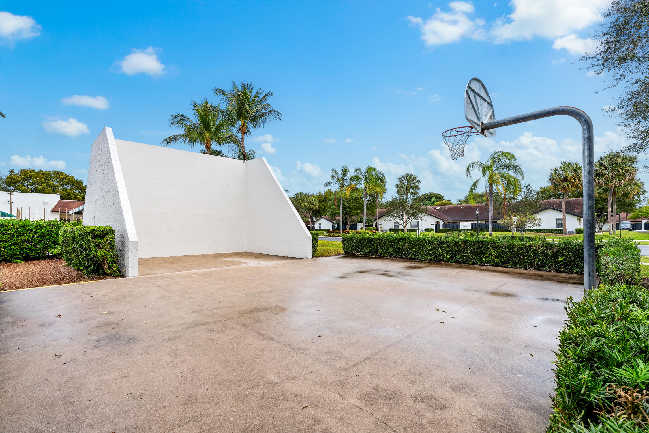 23368 Southwest 53rd Avenue, Unit C Boca Raton, FL 33433 - Photo 31 of 32 a front view of a house with a yard and garage