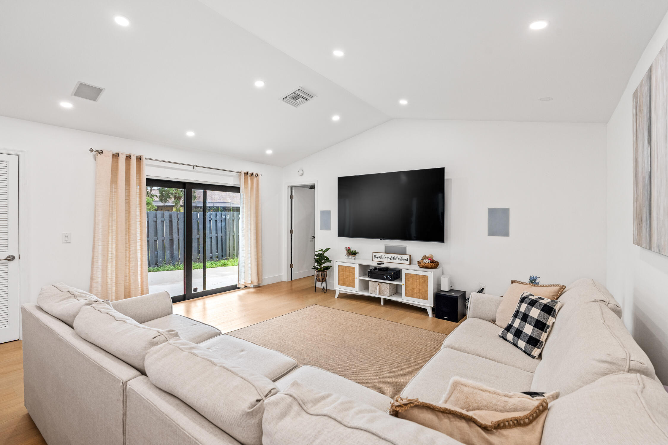 23368 Southwest 53rd Avenue, Unit C Boca Raton, FL 33433 - Photo 7 of 32 a living room with furniture and a flat screen tv