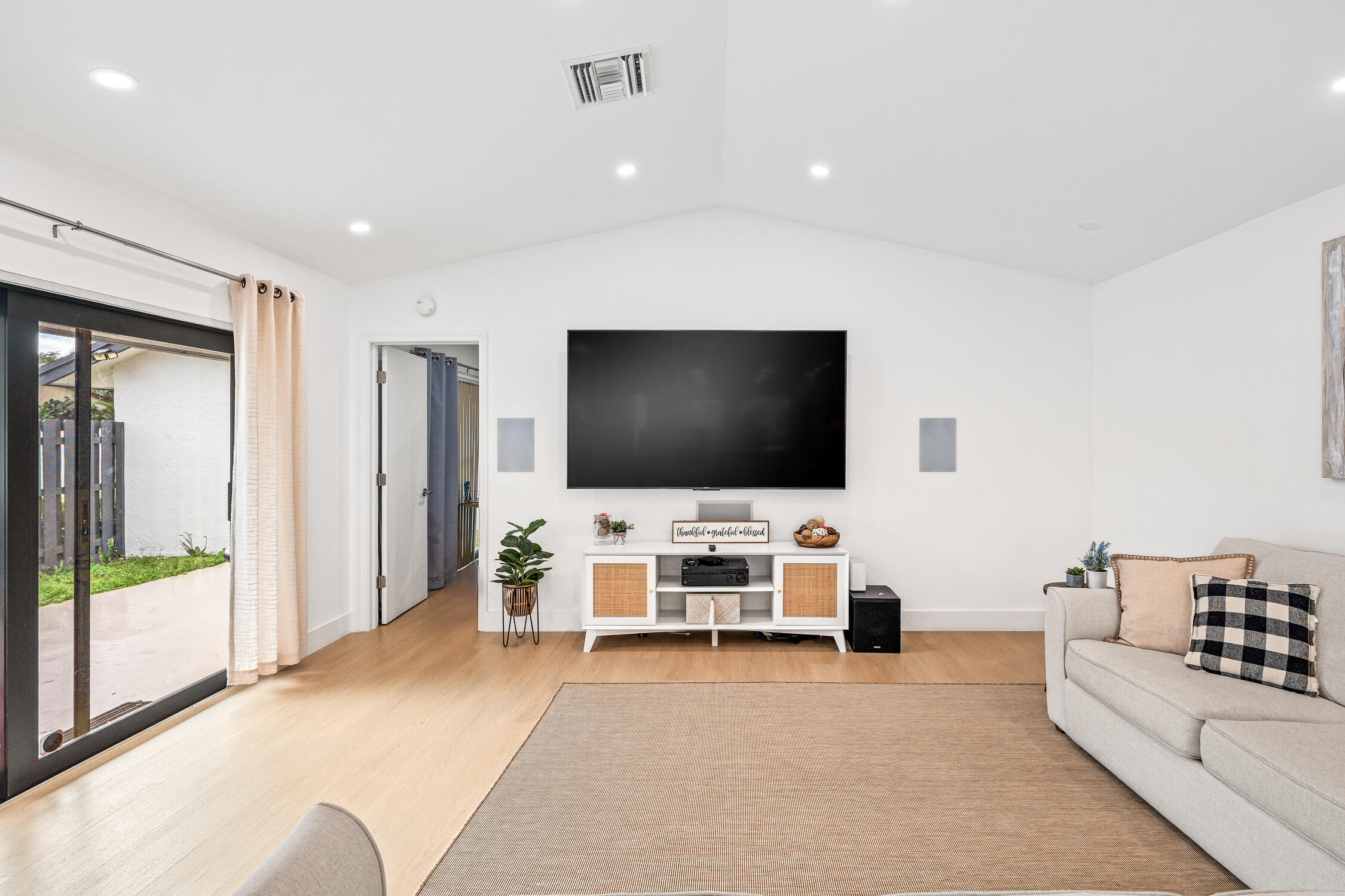 23368 Southwest 53rd Avenue, Unit C Boca Raton, FL 33433 - Photo 8 of 32 a living room with furniture and a flat screen tv
