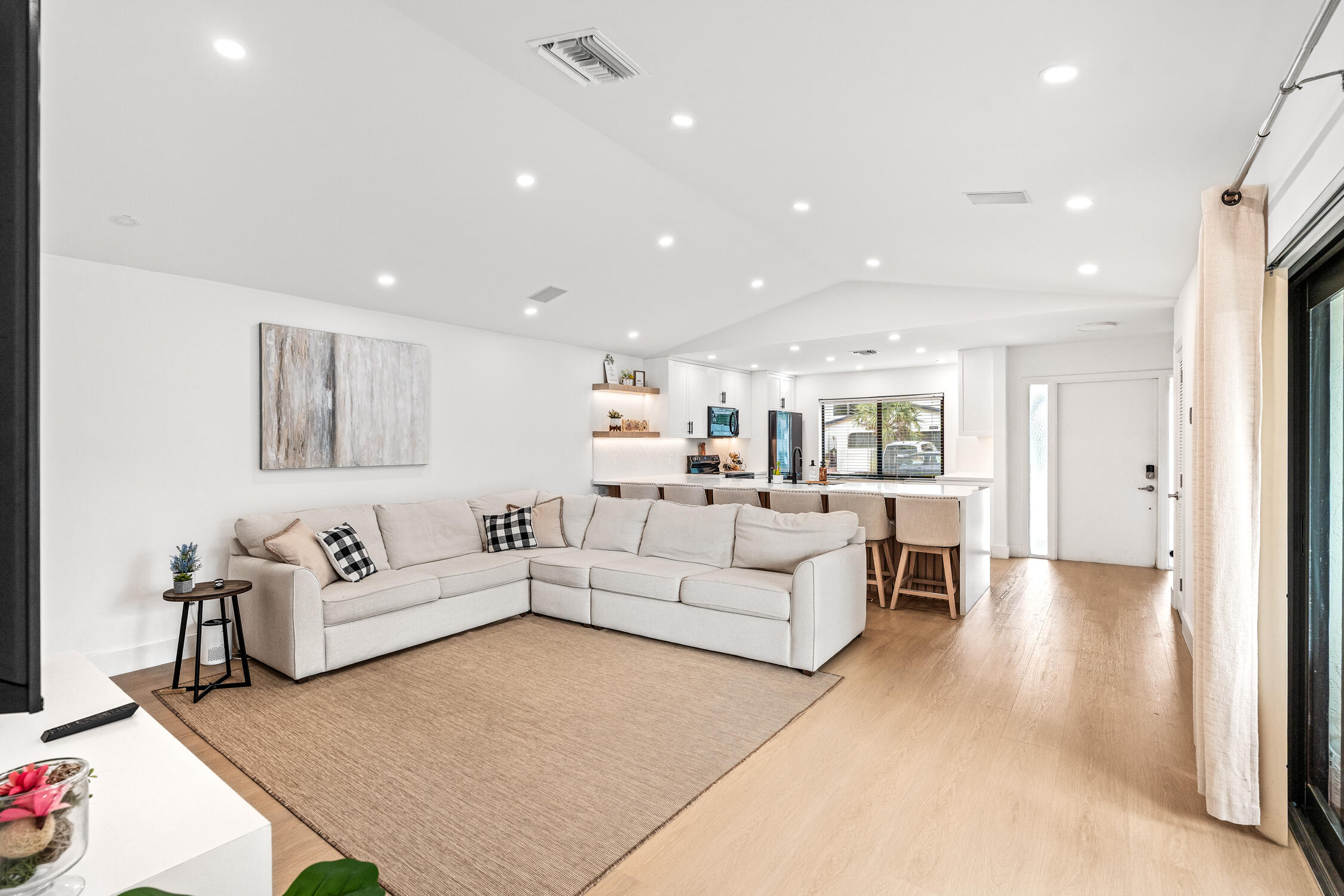 23368 Southwest 53rd Avenue, Unit C Boca Raton, FL 33433 - Photo 9 of 32 a living room with furniture and a view of kitchen