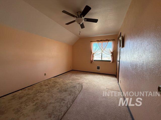 848 Jonathan Road Weiser, ID 83672 - Photo 18 of 42 Bonus room featuring light colored carpet, ceiling fan, and a textured wall