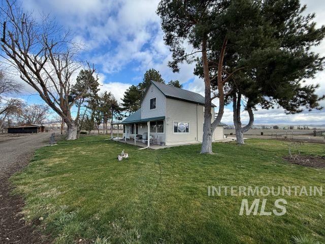 848 Jonathan Road Weiser, ID 83672 - Photo 26 of 42 Rear view of house with a patio area and a yard