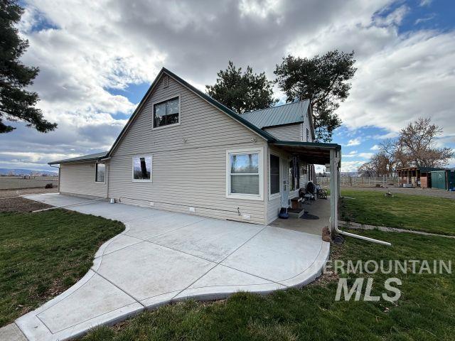 848 Jonathan Road Weiser, ID 83672 - Photo 27 of 42 View of home's exterior featuring a yard and a patio area
