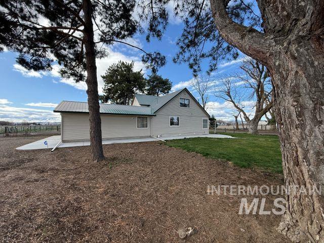 848 Jonathan Road Weiser, ID 83672 - Photo 28 of 42 View of side of home featuring a patio area and a metal roof