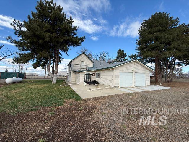848 Jonathan Road Weiser, ID 83672 - Photo 30 of 42 View of front of property featuring a front lawn, a patio area, and a garage