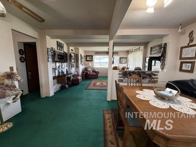848 Jonathan Road Weiser, ID 83672 - Photo 6 of 42 Dining area with dark colored carpet and beamed ceiling