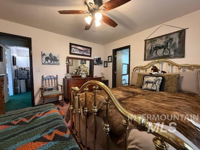 848 Jonathan Road Weiser, ID 83672 - Photo 9 of 42 Bedroom with ceiling fan, dark colored carpet, and connected bathroom