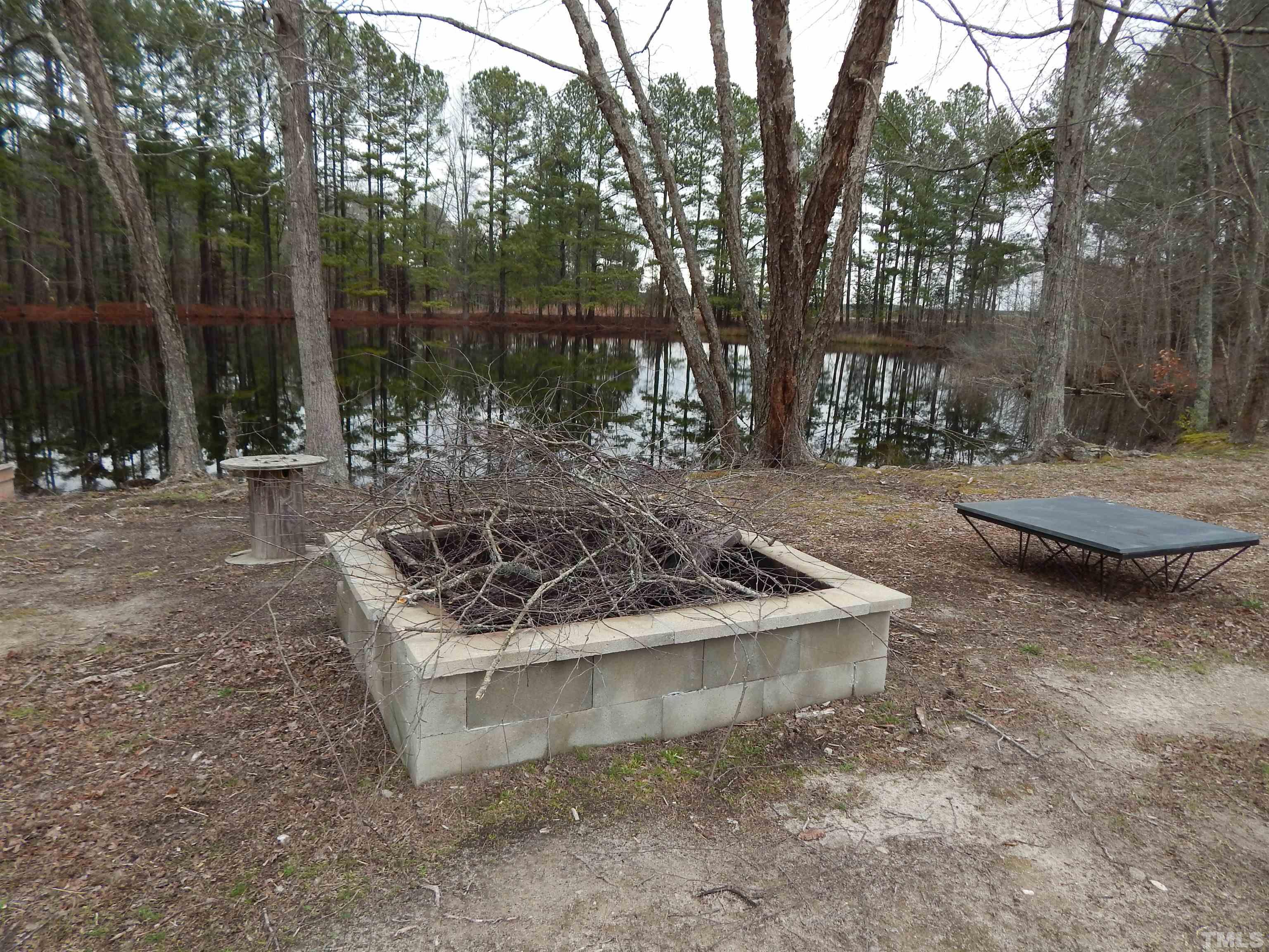 3185 Walters Road Creedmoor, NC 27522 - Photo 29 of 30 a wooden bench sitting in the middle of a yard