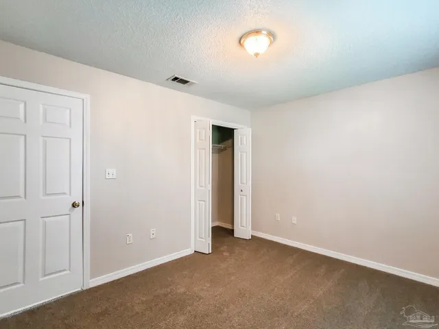 an empty room with closet area