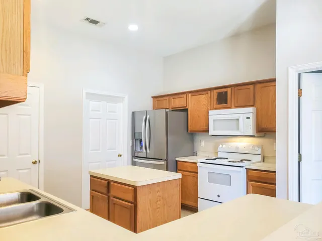 a kitchen with stainless steel appliances a stove and a refrigerator