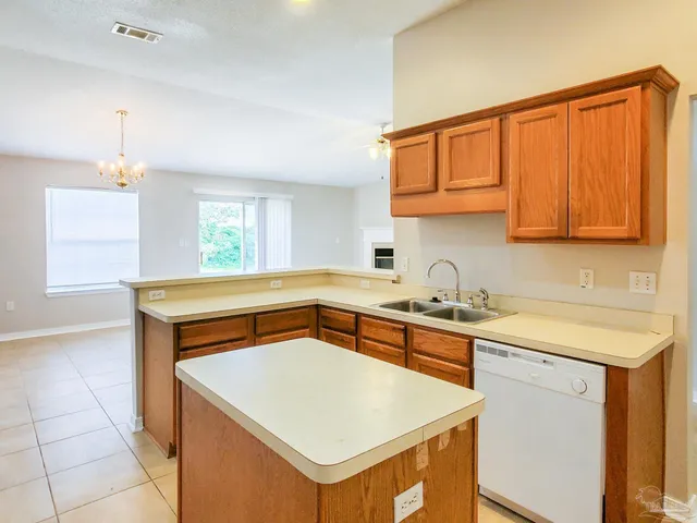 a kitchen with a sink cabinets and window