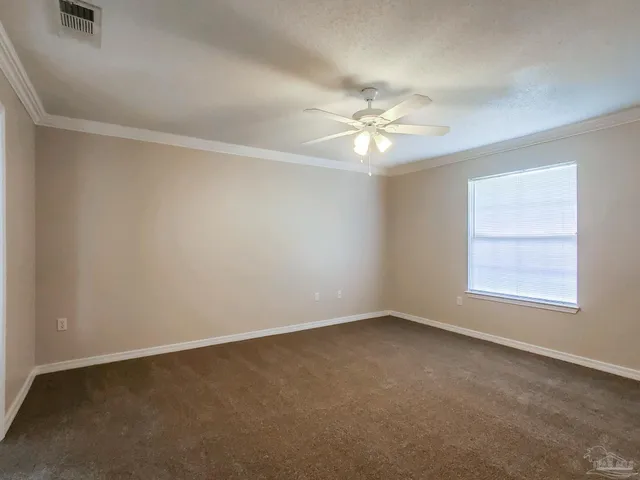 an empty room with a window and a fan