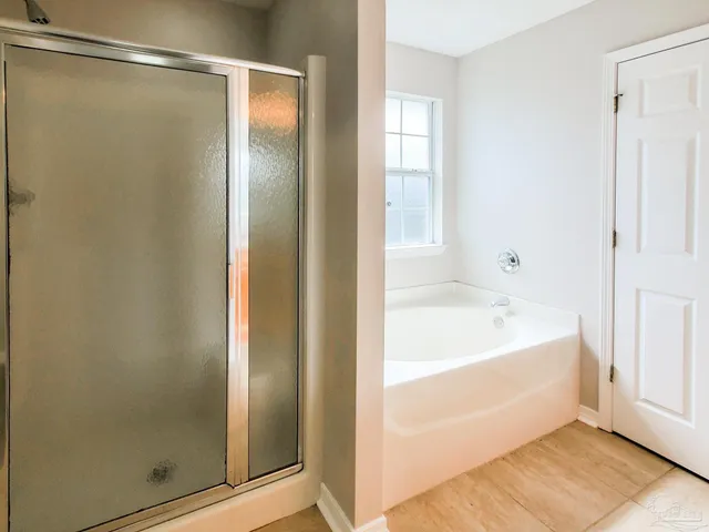 a bathroom with a bathtub and shower