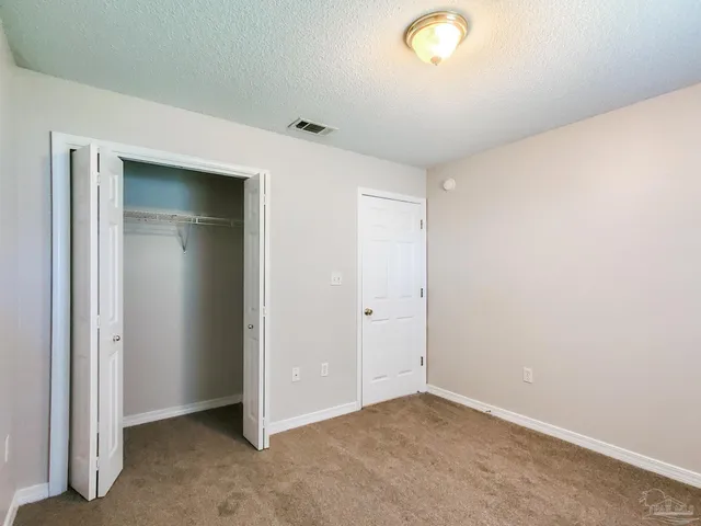 an empty room with closet area