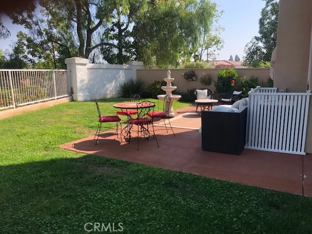 a backyard of a house with table and chairs