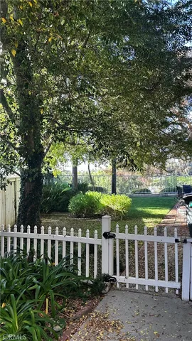 a backyard of a house with lots of green space and fountain