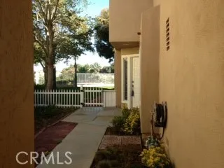 a porch with a bench next to a yard