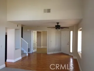 a kitchen with stainless steel appliances wooden floor and a refrigerator