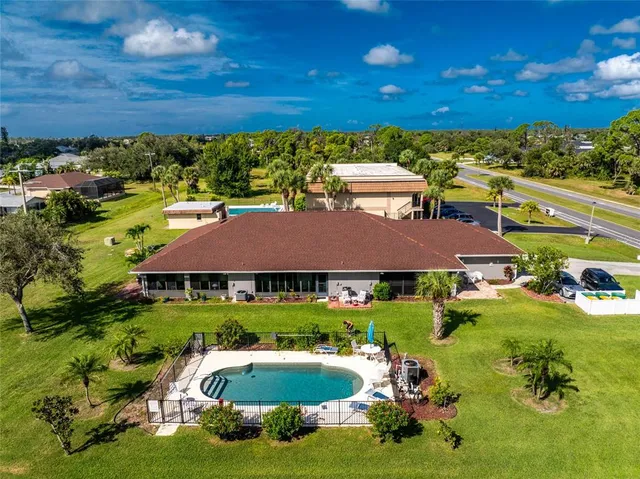 a aerial view of a house with yard swimming pool and outdoor seating