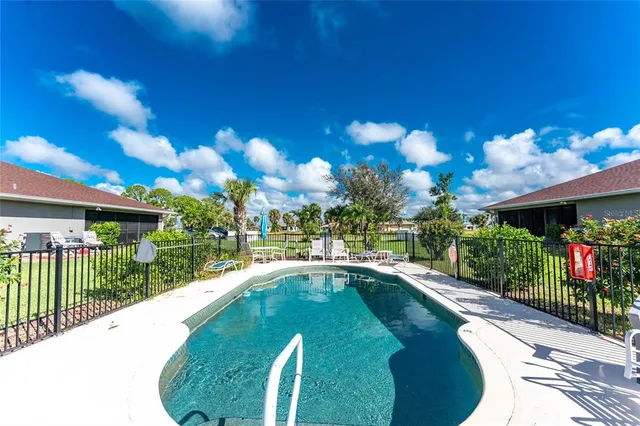 a view of a house with swimming pool and sitting area