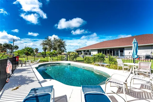 a view of a swimming pool with a lot of flower plants