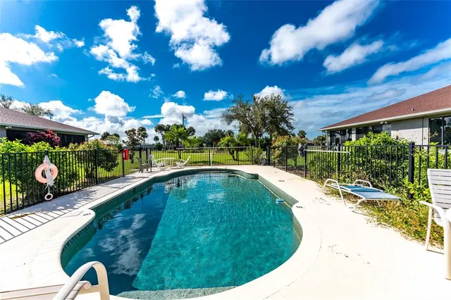 an aerial view of a house with a yard and garden space