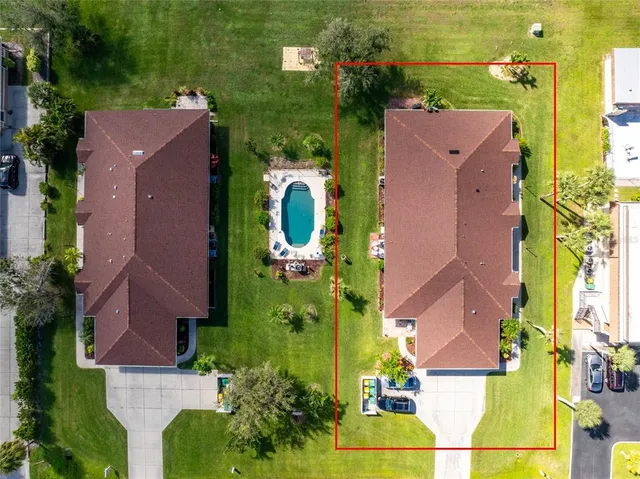an aerial view of house with yard swimming pool and outdoor seating