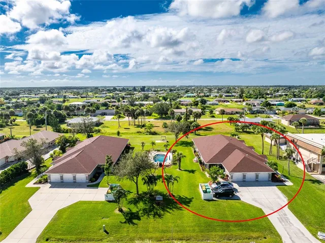 an aerial view of residential houses with outdoor space