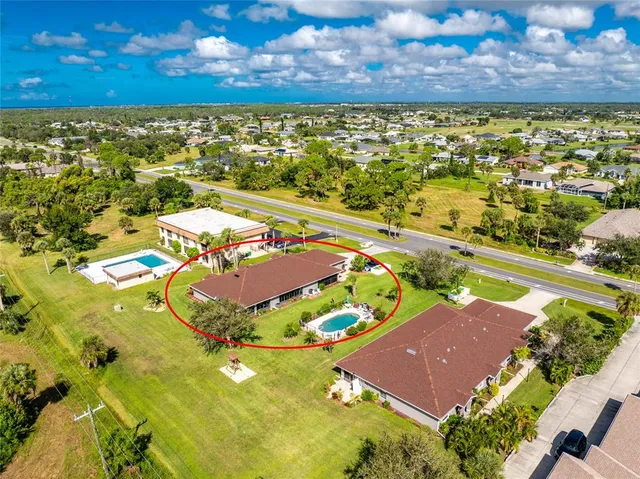 an aerial view of residential houses with outdoor space and river