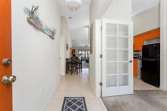 a view of kitchen with stainless steel appliances granite countertop a refrigerator and a stove top oven