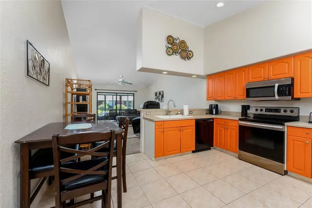 a kitchen with stainless steel appliances granite countertop a stove refrigerator and a sink