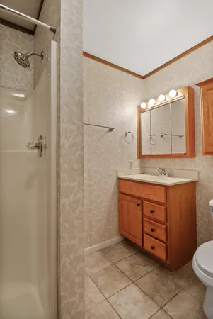 a bathroom with a granite countertop sink mirror and toilet