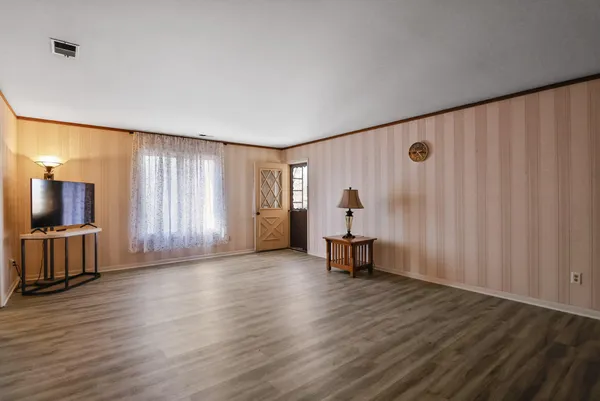 a view of a livingroom with furniture and a window