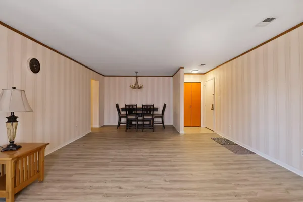 a view of an empty room with wooden floor