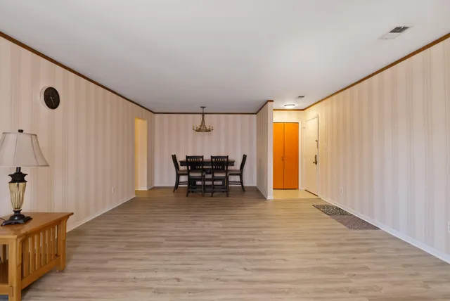 a view of an empty room with wooden floor