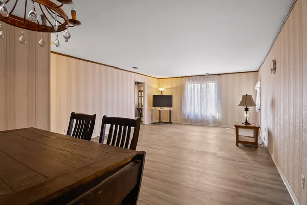 a view of a bedroom with furniture and wooden floor