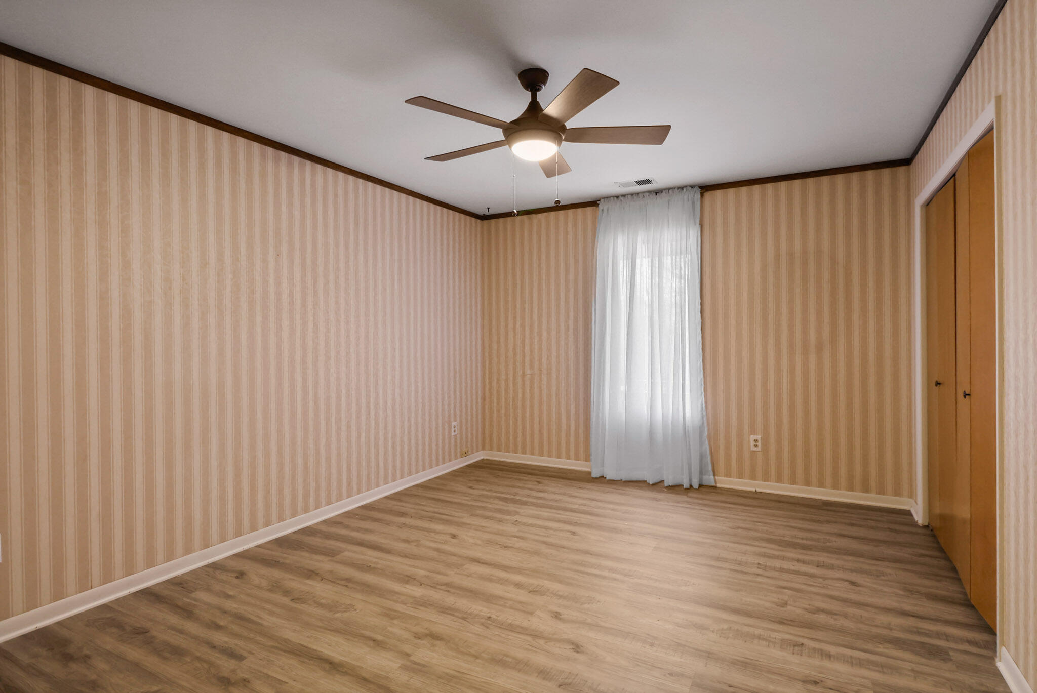 8825 Janeway Court, Unit 8 Munster, IN 46321 - Photo 10 of 17 an empty room with wooden floor chandelier fan and windows