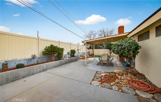 a view of a patio with table and chairs and potted plants