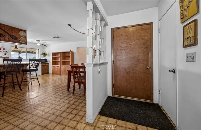 a view of a livingroom with furniture and an entryway