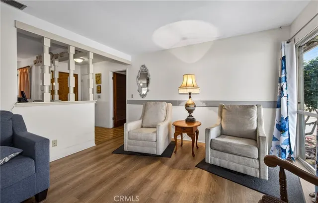 a living room with furniture and a lamp
