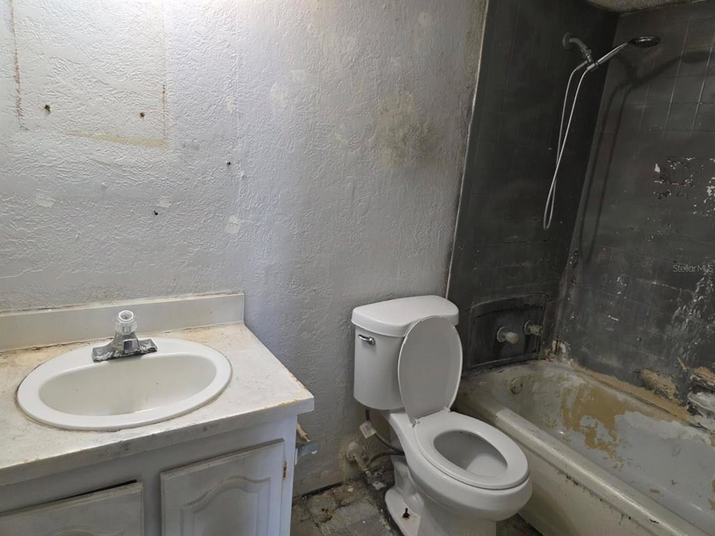 2789 L B McLeod Road, Unit D Orlando, FL 32805 - Photo 5 of 5 a bathroom with a sink toilet and shower