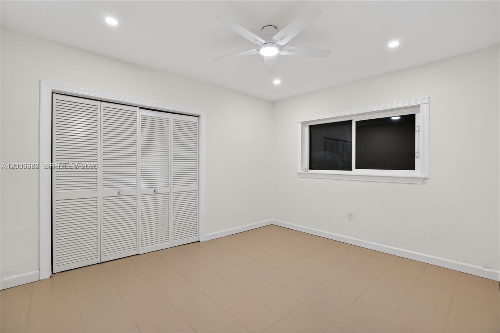 1435 Blue Road Coral Gables, FL 33146 - Photo 18 of 31 an empty room with a ceiling fan and a window