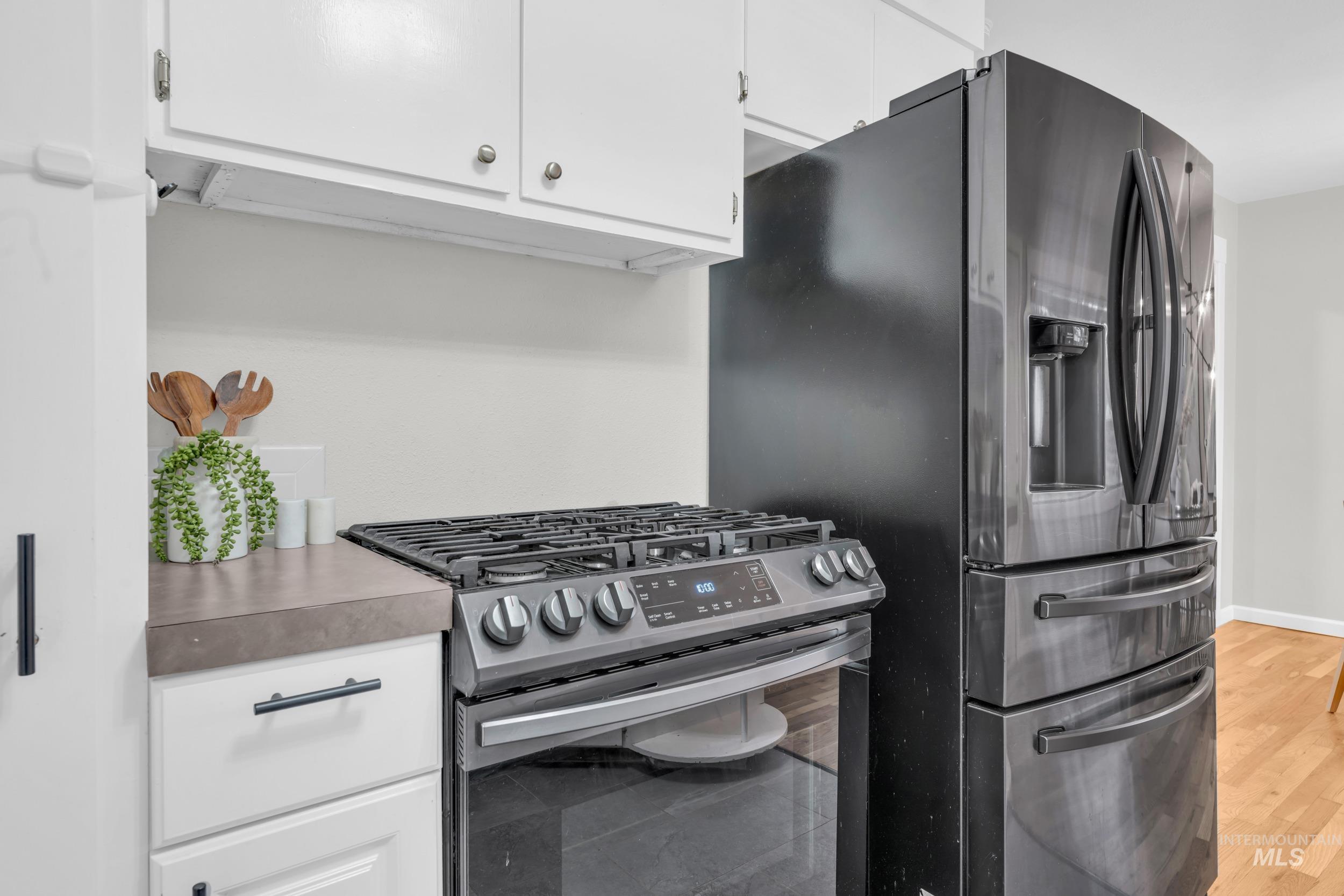 2908 Meadowbrook Drive Boise, ID 83705 - Photo 12 of 29 Kitchen with stainless steel appliances and white cabinets