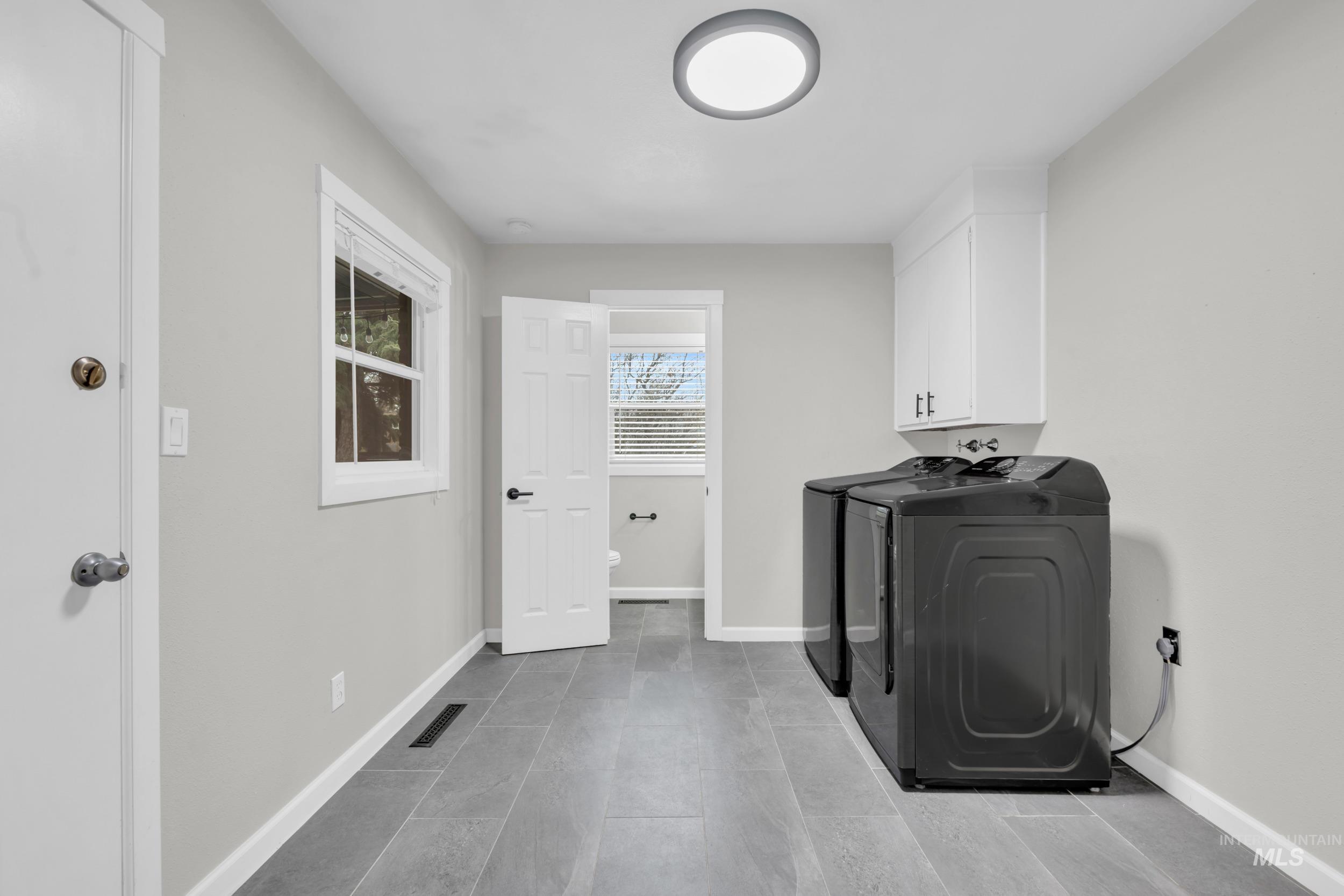 2908 Meadowbrook Drive Boise, ID 83705 - Photo 23 of 29 Washroom with cabinet space and separate washer and dryer