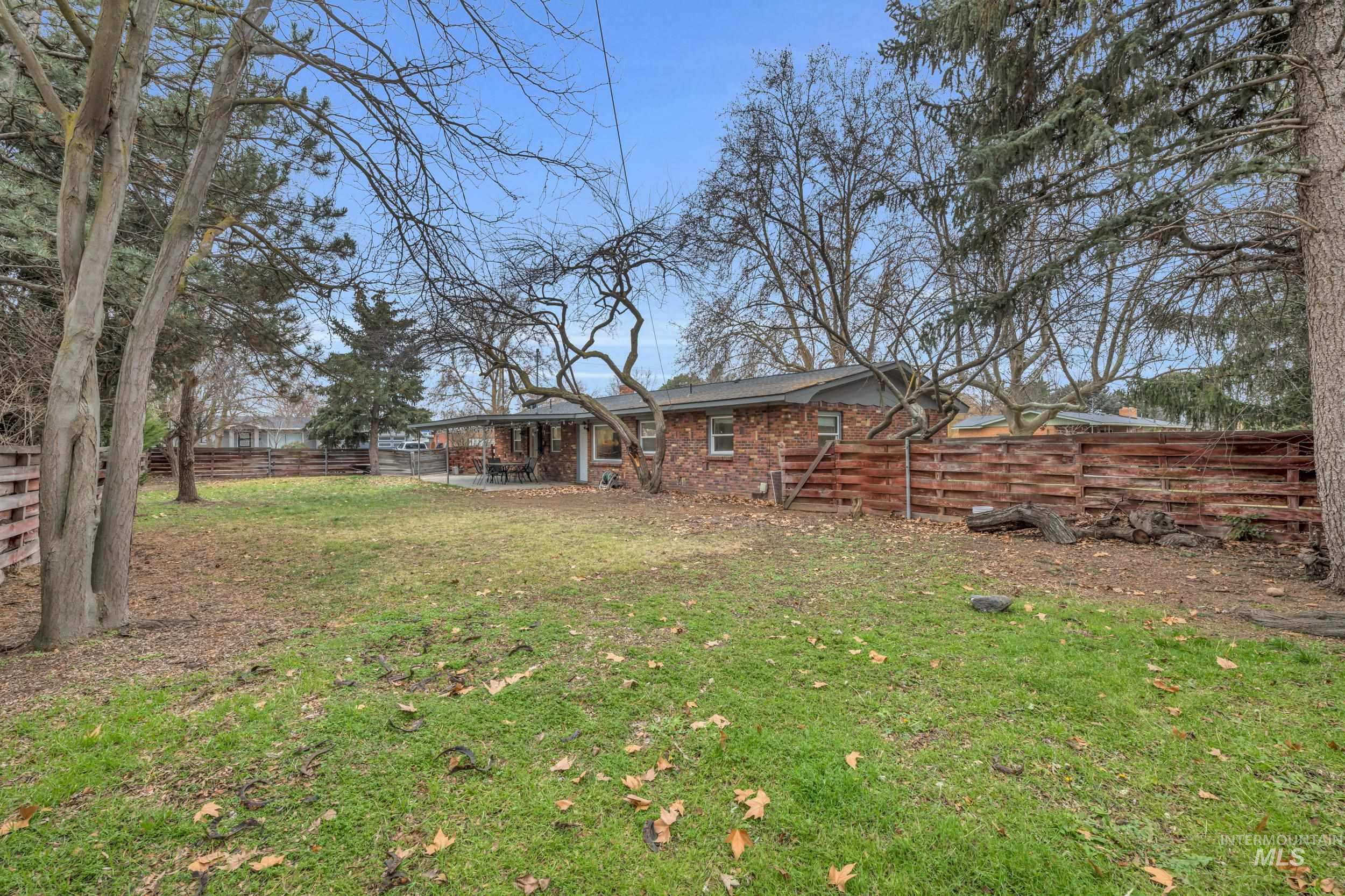 2908 Meadowbrook Drive Boise, ID 83705 - Photo 28 of 29 Rear view of property featuring a fenced backyard and brick siding